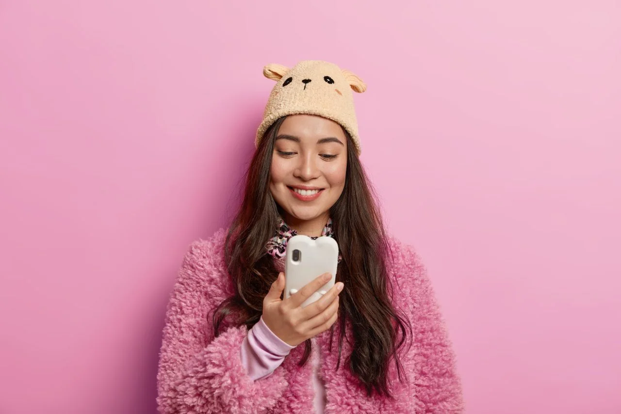 Smiling employee answering a survey on her phone