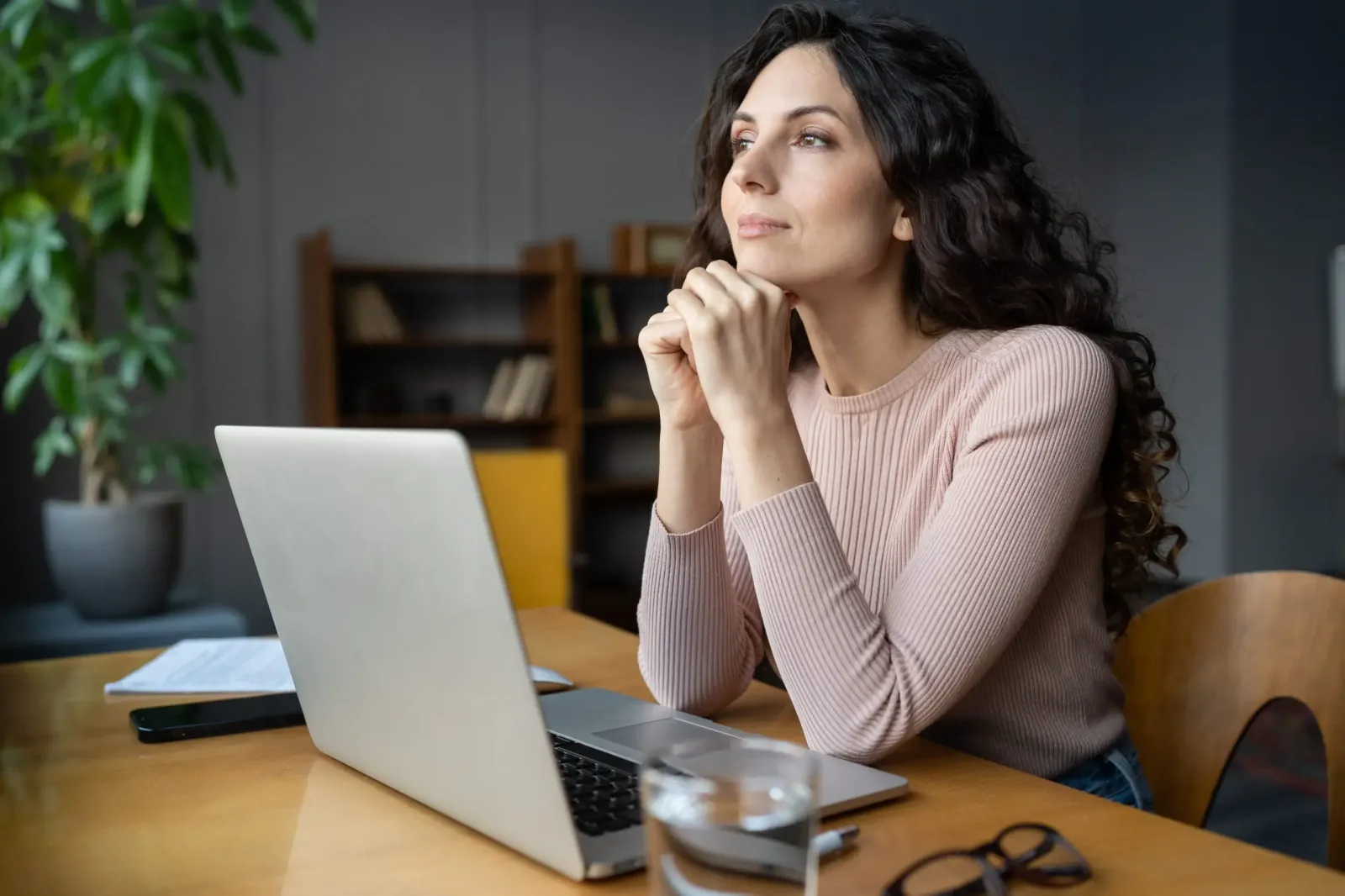 A fulfilled, relaxed employee at her workstation