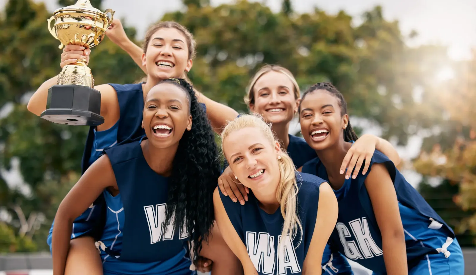 A sports team celebrating with a trophy