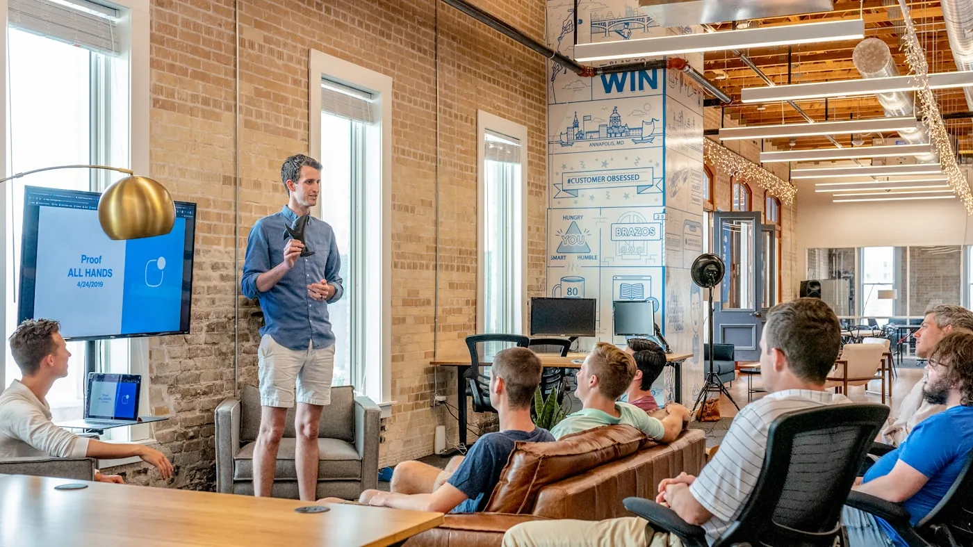 Presenter sharing a recruitment strategy with their team in a modern workspace
